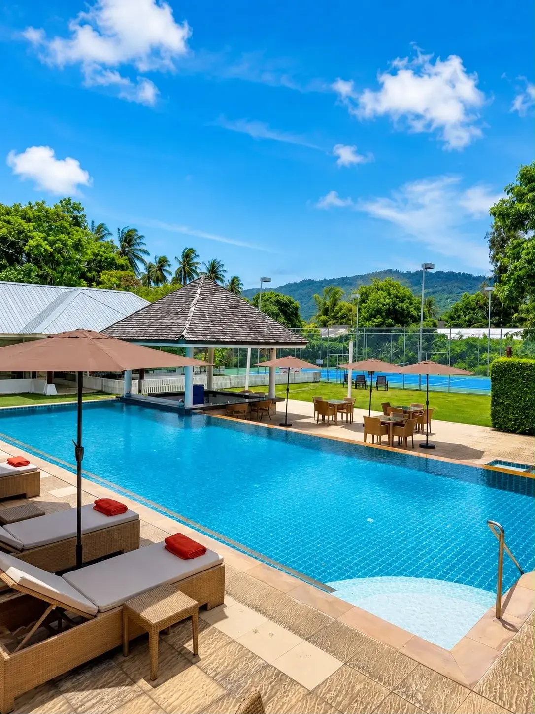 Swimming pool and tennis courts seen from the sun deck at Shi Shi Samui in Lamai, Koh Samui